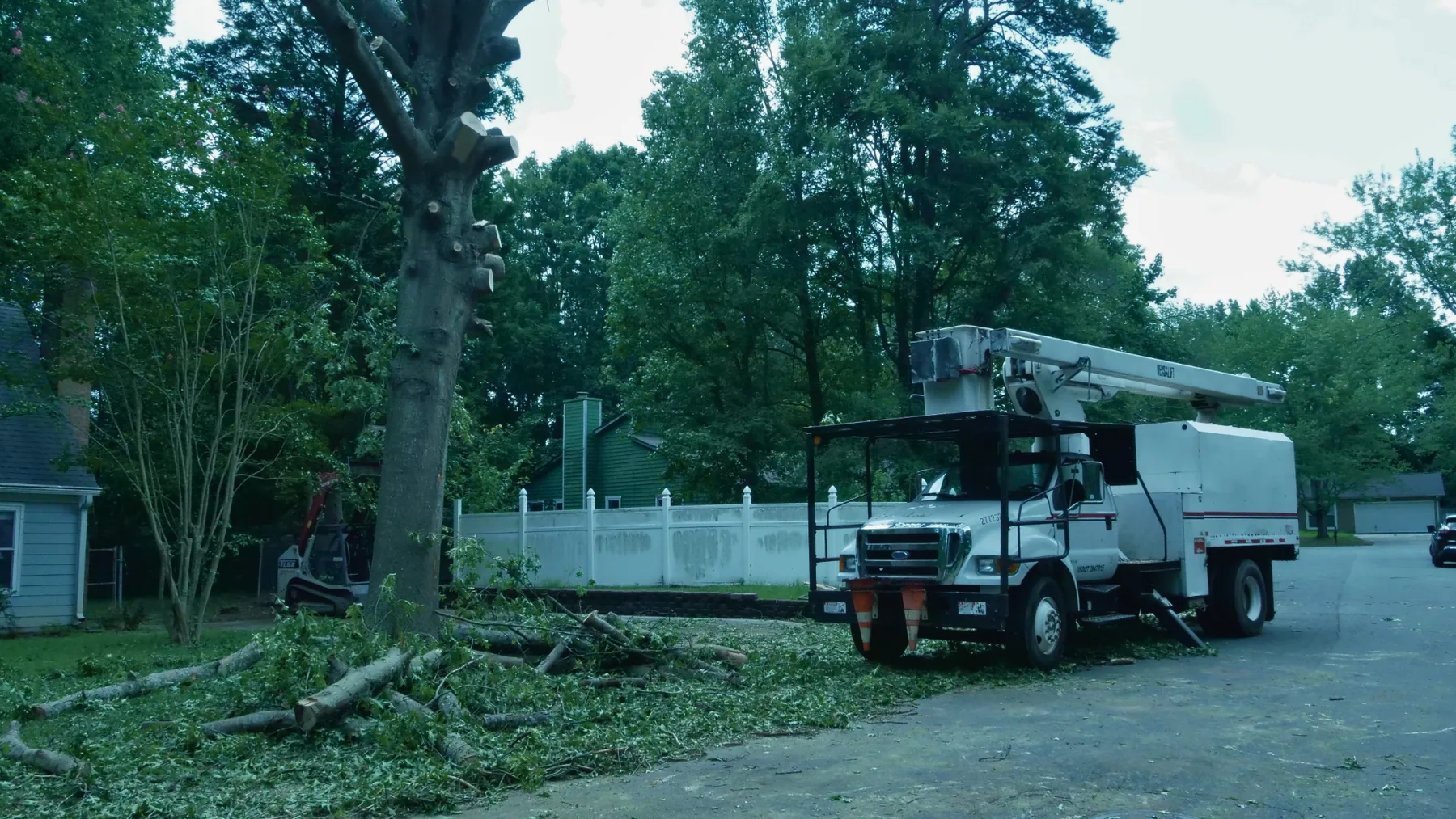 Bucket truck and tree removal equipment at a residential property